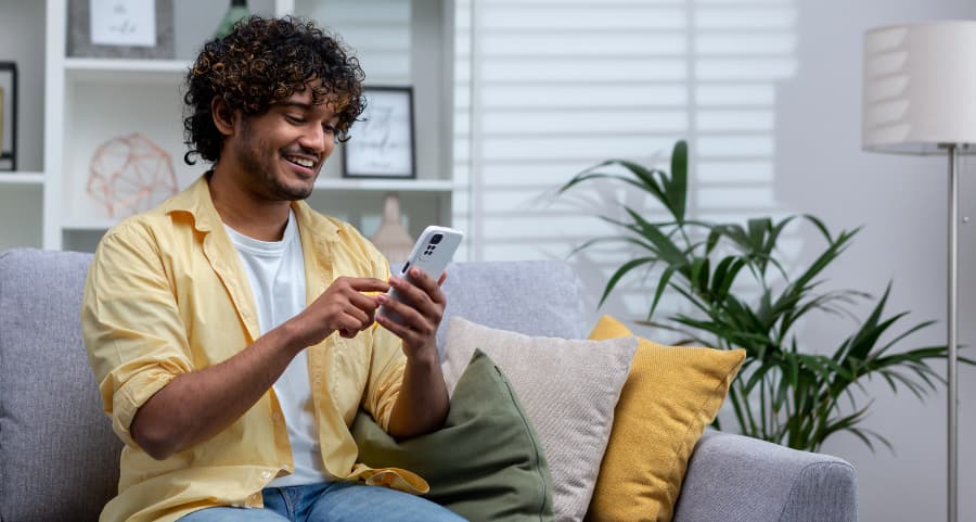 Homeowner using a home security app on his smartphone